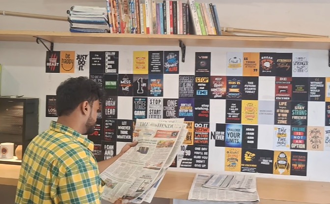 Student reading newspaper and books at Shyam Library